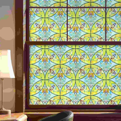ADD.HERES Floral Sequence 3D Stained Glass Window Film: Vibrant yellow & blue boho privacy window film for large living room windows.
